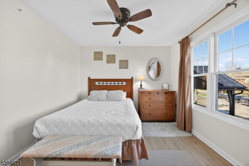 10-11 Pine Crescent, Unit 21 Vernon, NJ 07462 - Photo 33 of 50 a bedroom with a bed and dresser with mirror