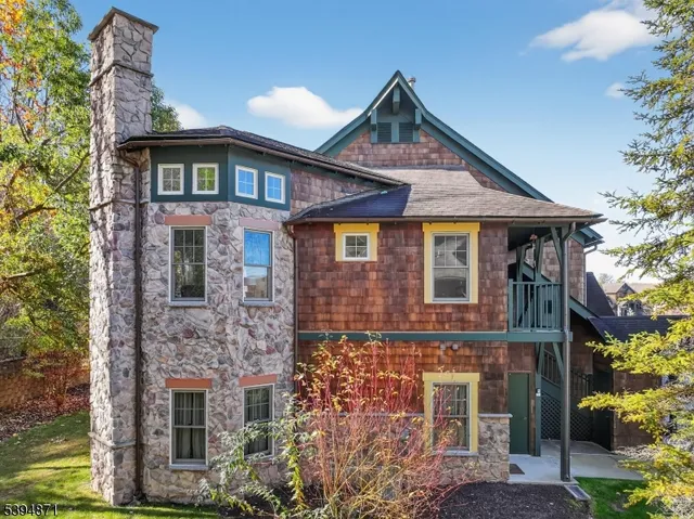 a living room with furniture a fireplace and a chandelier