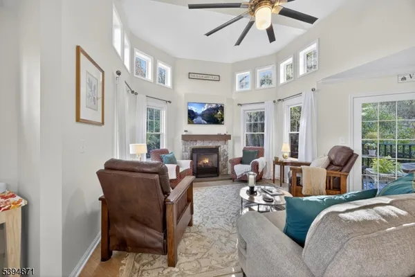 a living room with furniture a fireplace and a chandelier