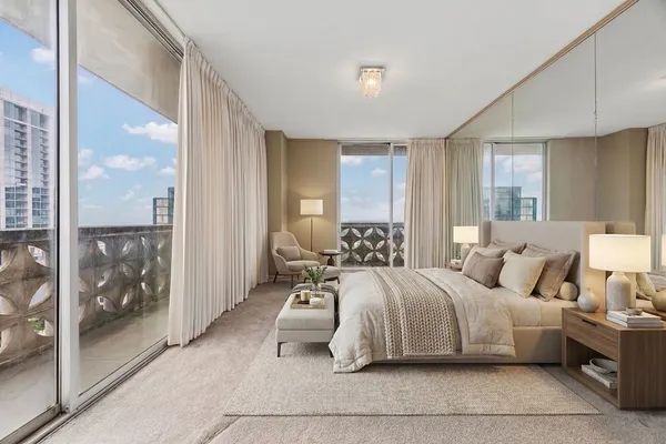 a bedroom with a large bed and a large window