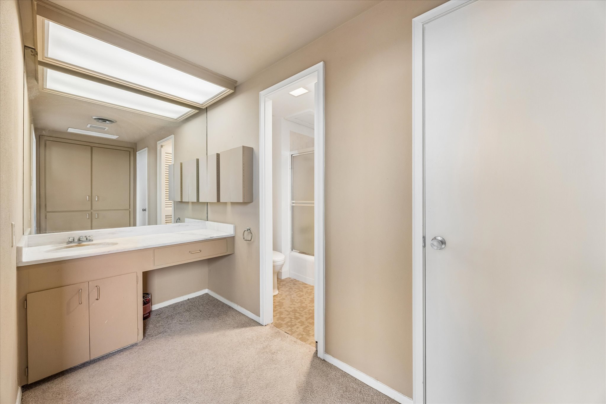 1801 Lavaca Street, Unit 14K Austin, TX 78701 - Photo 11 of 30 a bathroom with a sink and a mirror