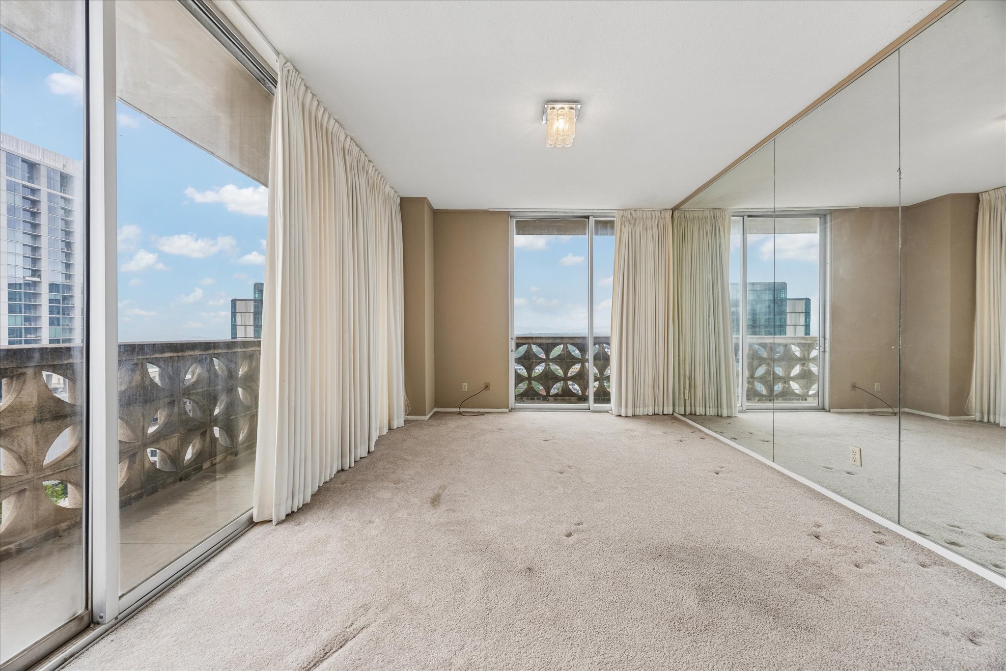 1801 Lavaca Street, Unit 14K Austin, TX 78701 - Photo 9 of 30 a view of an empty room with glass door