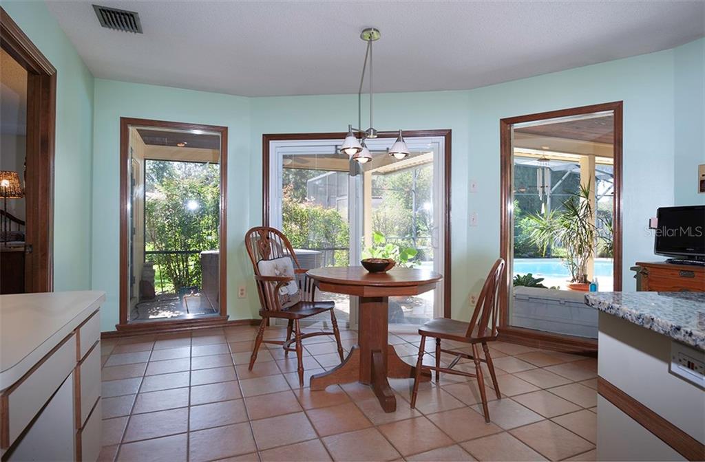 145 Spring Chase Circle Altamonte Springs, FL 32714 - Photo 17 of 54 Large eat-in space in the kitchen along with a built in desk area to the left.