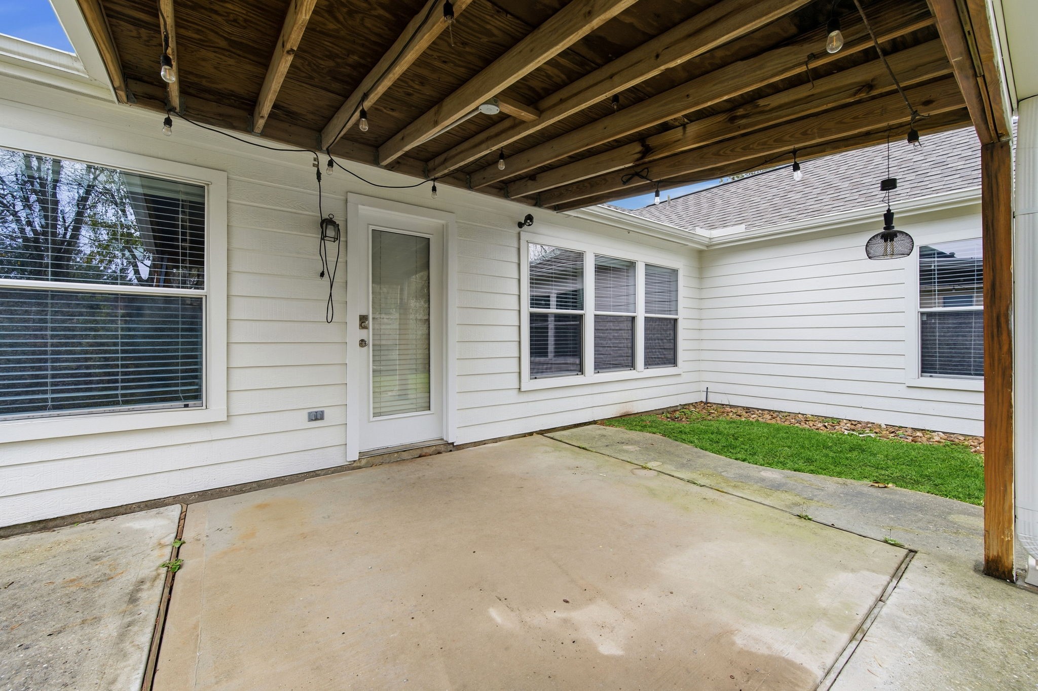 1910 Katlyn Lane Spring, TX 77386 - Photo 32 of 35 Covered patio for relaxing and enjoying quiet time in the private backyard. The patio opens to a small grassy area, ideal for outdoor activities.