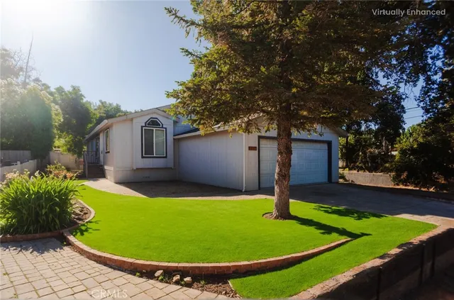 a view of a backyard with table and chairs with wooden fence and plants