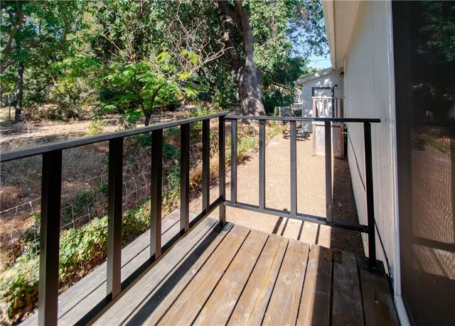 a view of balcony with wooden floor and fence