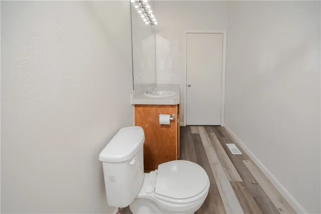 a white toilet sitting next to a shower curtain