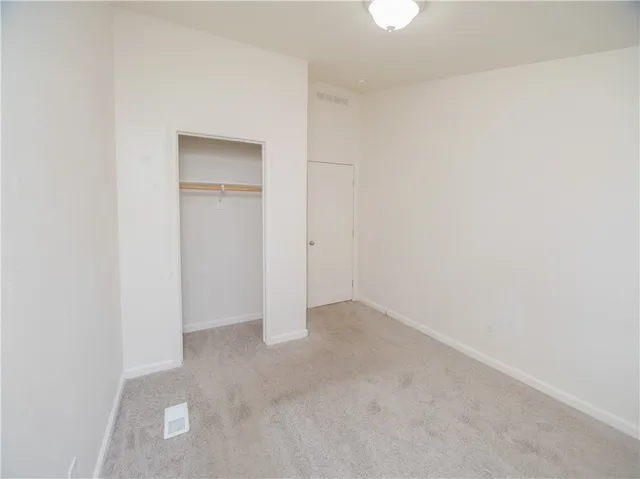 a view of an empty room and closet area