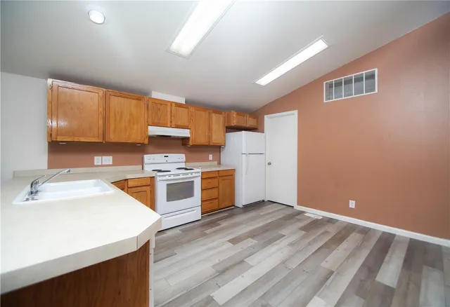 a kitchen with a stove a sink and a refrigerator