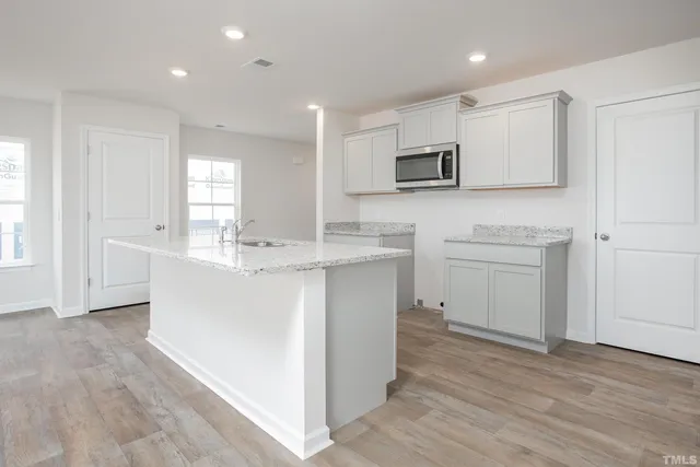 a kitchen with cabinets stove and oven