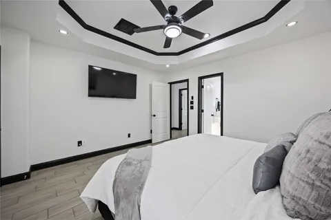 a bedroom with a large bed and a flat screen tv