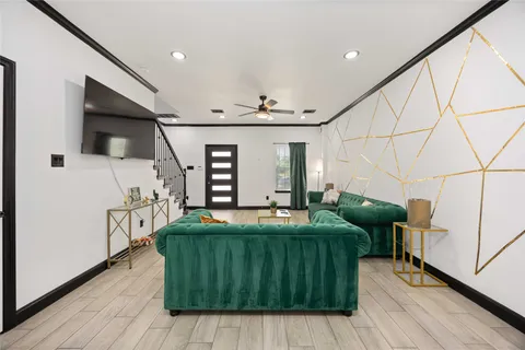 a kitchen with granite countertop a table chairs microwave and cabinets