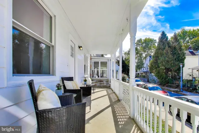 a view of a patio with couches table and chairs and potted plants