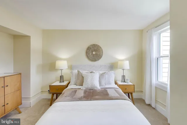 a bed room with a bed and a lamp