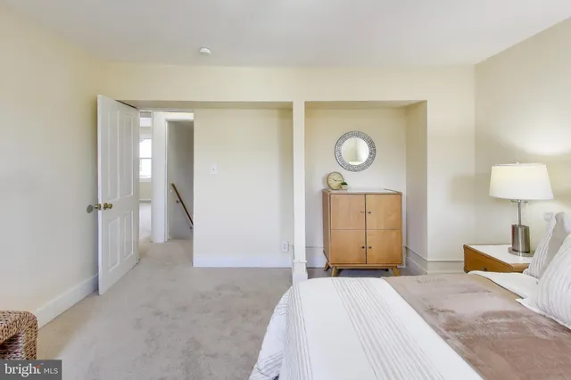 a bedroom with a bed and a lamp