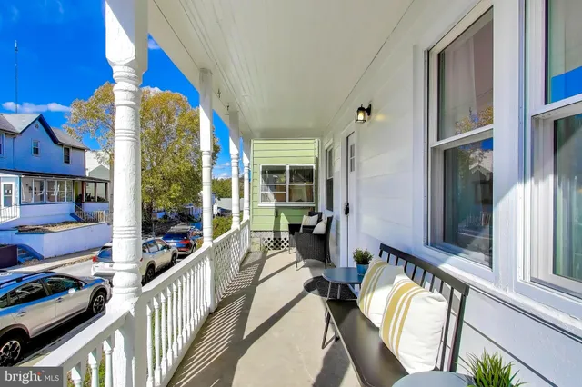 a view of a balcony and car parked