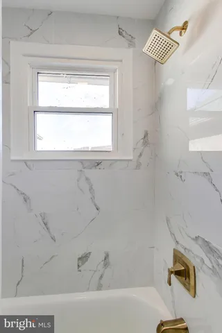 a bathroom with a window and a bathtub