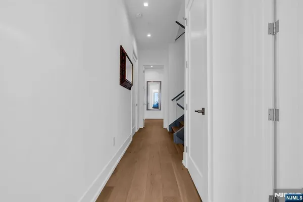 a view of a hallway with a white walls and stairs