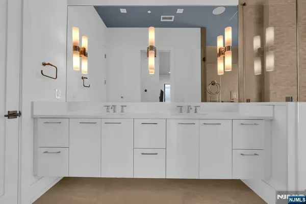 a bathroom with a double vanity sink and a mirror