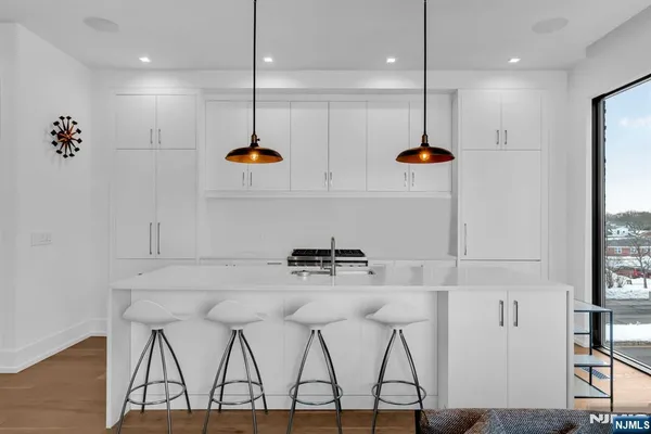 a kitchen with a refrigerator a sink and cabinets