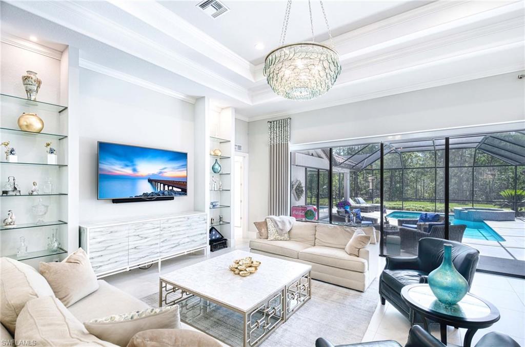 7516 Treeline Drive Naples, FL 34119 - Photo 1 of 33 a living room with furniture a rug and a flat screen tv