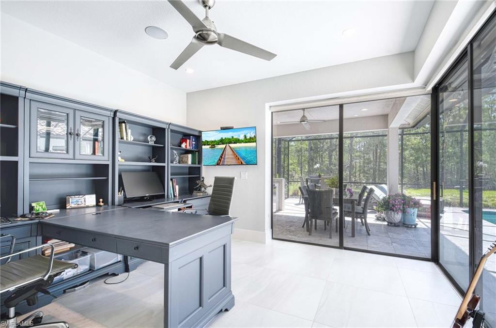 7516 Treeline Drive Naples, FL 34119 - Photo 11 of 33 a workspace with furniture and a floor to ceiling window