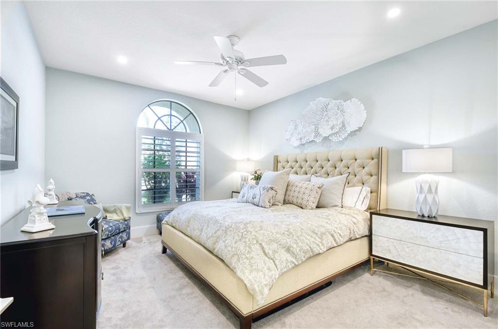 7516 Treeline Drive Naples, FL 34119 - Photo 15 of 33 a bedroom with a large bed and a window