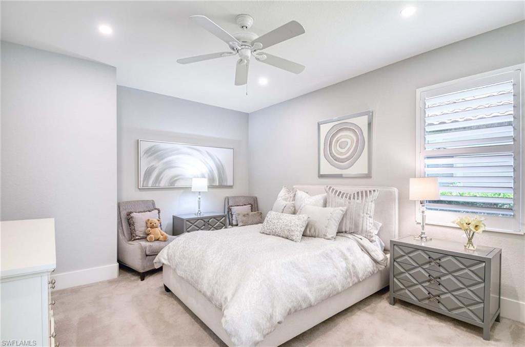 7516 Treeline Drive Naples, FL 34119 - Photo 17 of 33 a bedroom with bed and a chandelier