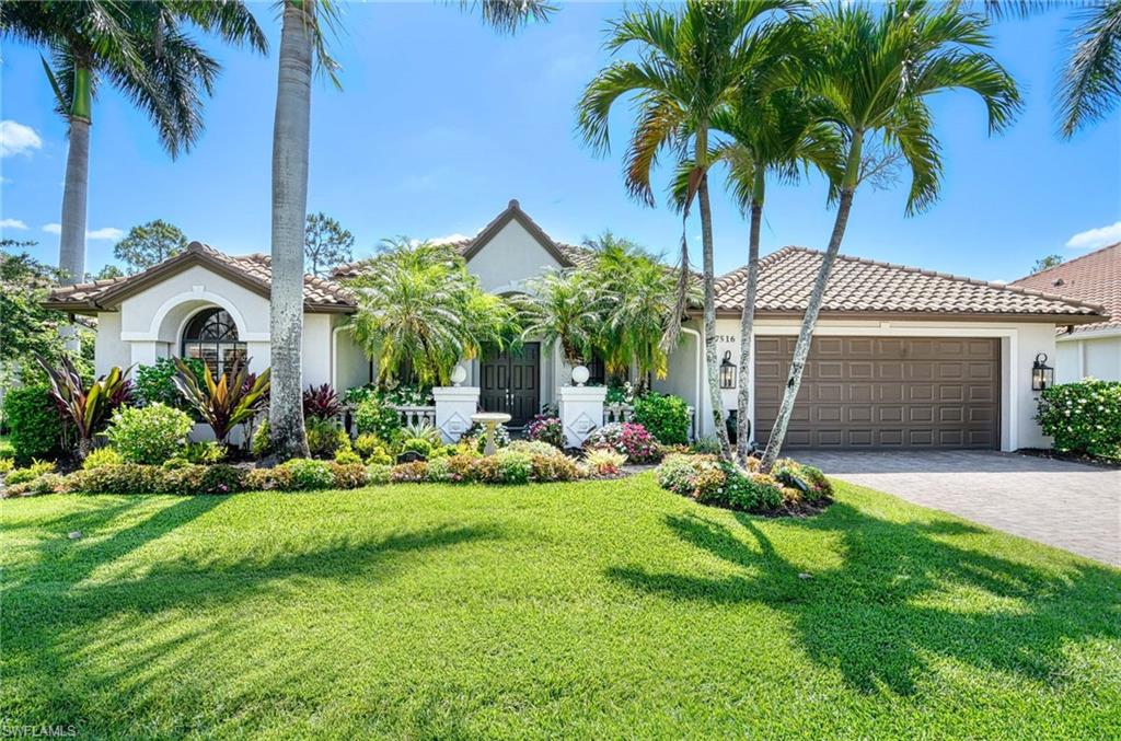 7516 Treeline Drive Naples, FL 34119 - Photo 23 of 33 a front view of a house with a garden and yard