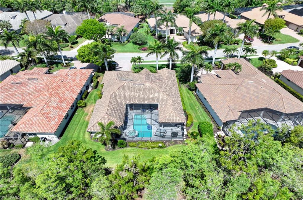 7516 Treeline Drive Naples, FL 34119 - Photo 25 of 33 an aerial view of a house with a yard and lake view