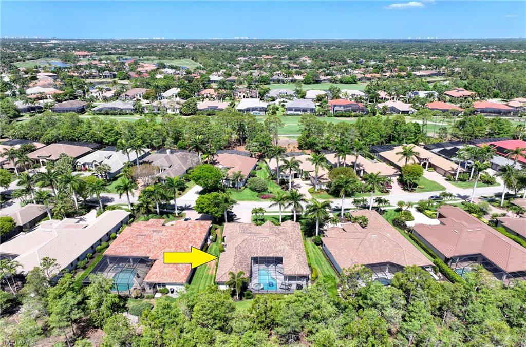 7516 Treeline Drive Naples, FL 34119 - Photo 26 of 33 an aerial view of a house with a swimming pool yard and outdoor seating