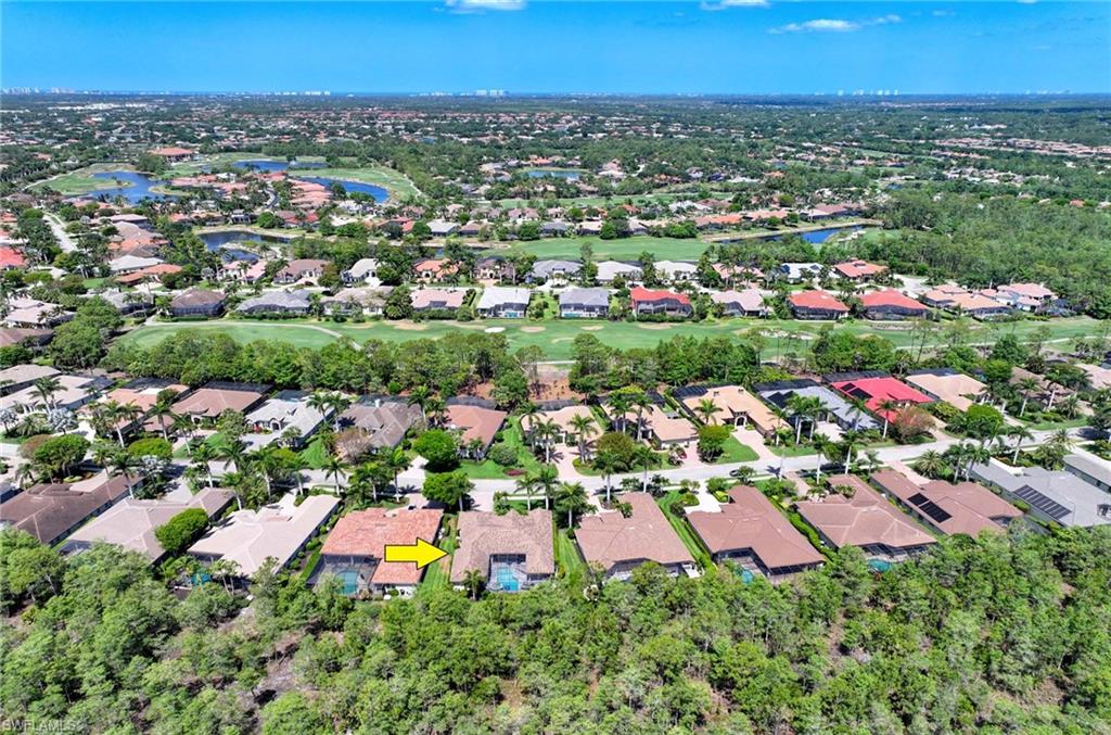 7516 Treeline Drive Naples, FL 34119 - Photo 28 of 33 an aerial view of a houses with a yard
