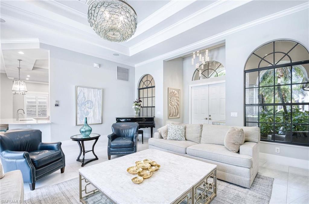7516 Treeline Drive Naples, FL 34119 - Photo 5 of 33 a living room with furniture a table and a large window