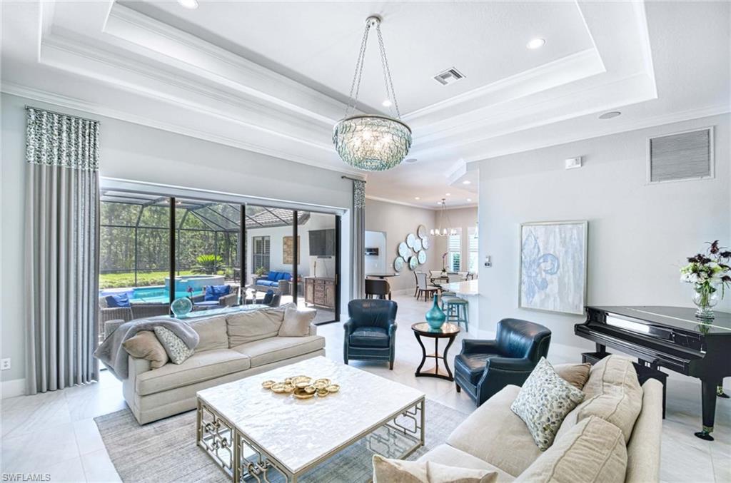 7516 Treeline Drive Naples, FL 34119 - Photo 7 of 33 a living room with furniture a table and a large window