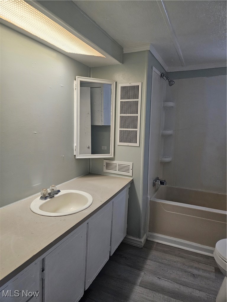 2305 East Waterloo Road Akron, OH 44312 - Photo 6 of 12 Full bath with vanity, tub / shower combination, dark wood-style floors, and a textured ceiling