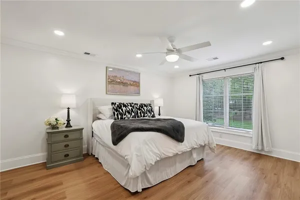 a bedroom with a large bed and a window