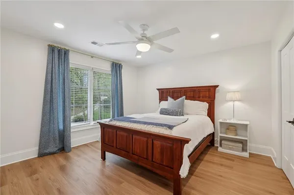 a bedroom with a large bed and a window