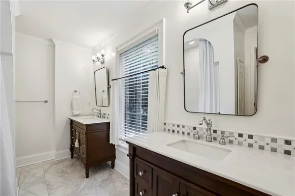 a bathroom with a double vanity sink mirror and double