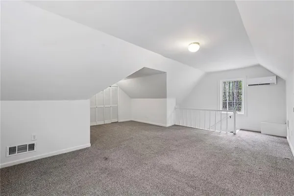 an empty room with windows and pillars in it