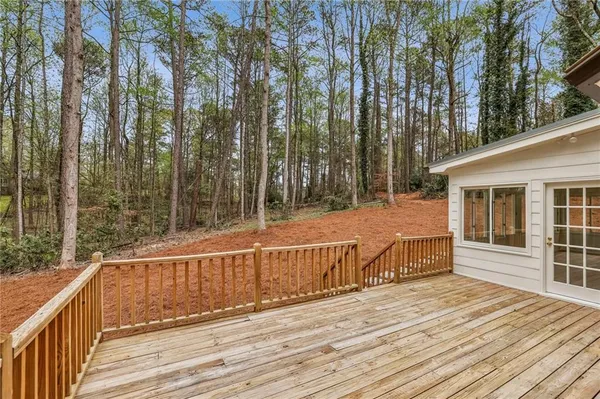 a view of a wooden deck with a yard