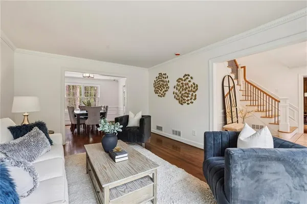 a living room with furniture and wooden floor