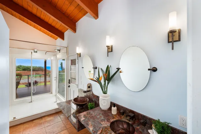 a living room with furniture a window and a potted plant