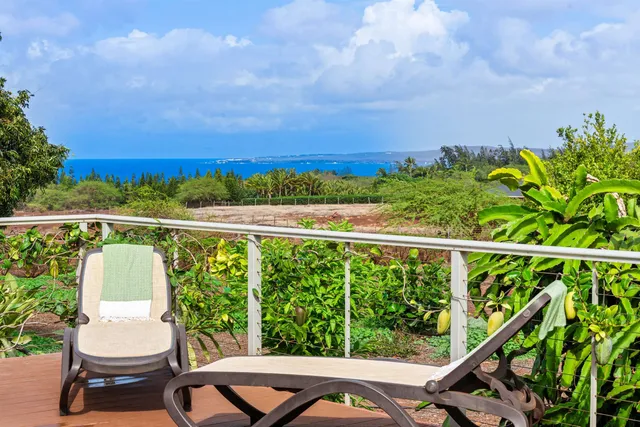 a view of a chair and tables in the balcony