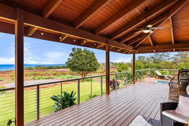 a view of a balcony with lake view and wooden floor