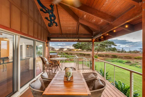 a view of a balcony with chair and wooden floor