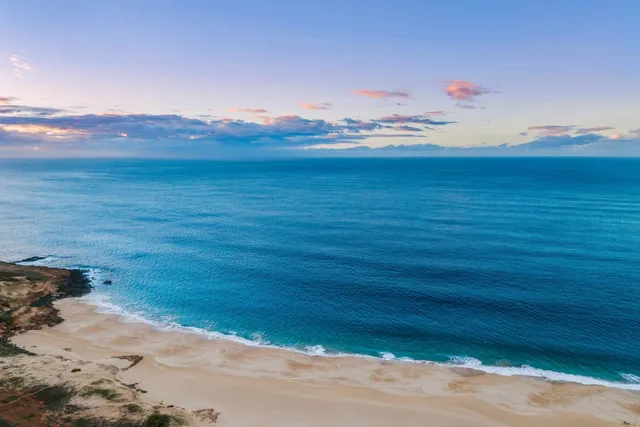 a view of an ocean beach and mountain