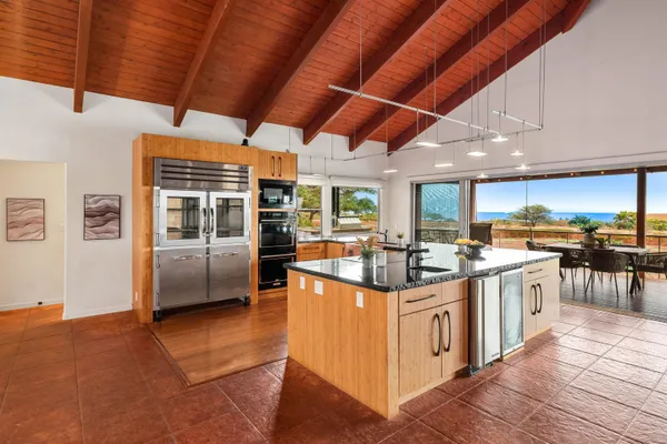 a kitchen with stainless steel appliances granite countertop a stove and a refrigerator