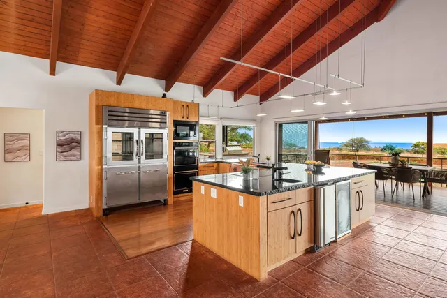 a kitchen with stainless steel appliances granite countertop a stove and a refrigerator