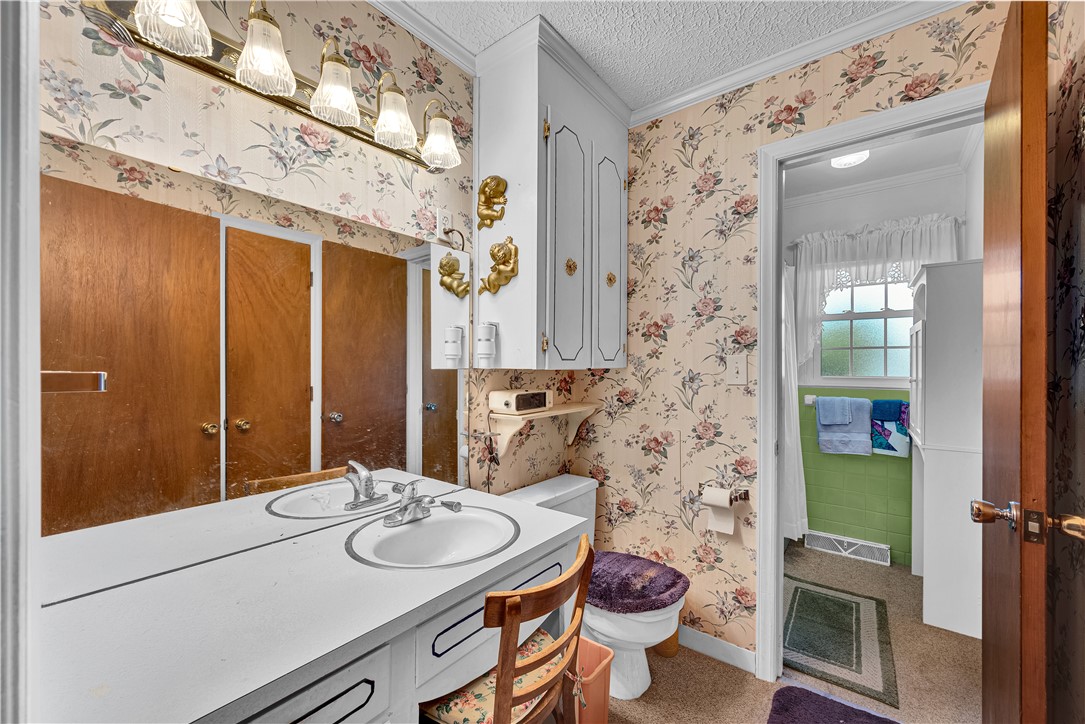 307 Calhoun Road Belton, SC 29627 - Photo 20 of 30 Double vanity sinks and bright overhead lighting create a practical and well-illuminated primary bathroom space.