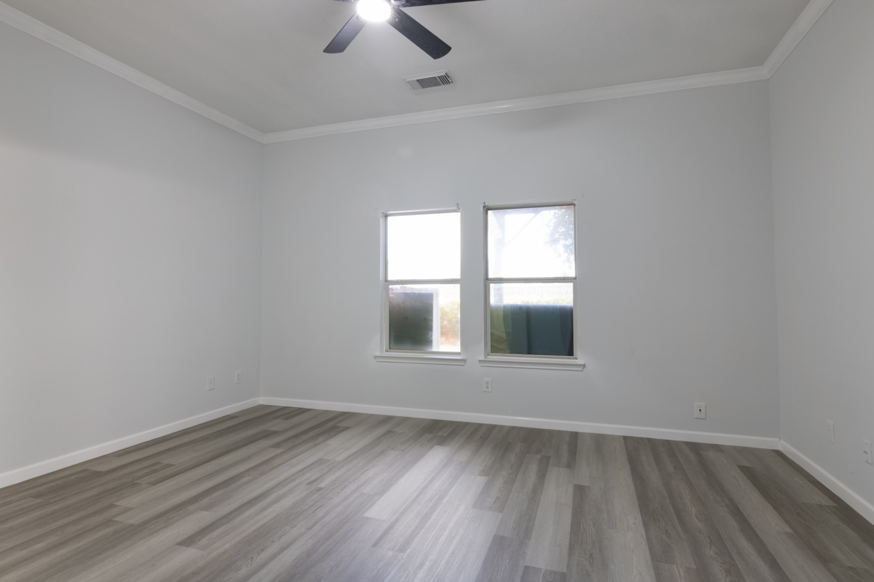 5326 Coast Line Street Baytown, TX 77521 - Photo 13 of 26 an empty room with wooden floor and windows